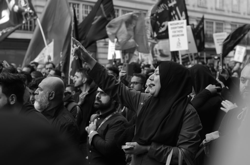 Hussain rally Central London hand on heart pointing to the sky